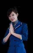 Aiyara Thai hostess in traditional blue Thai dress